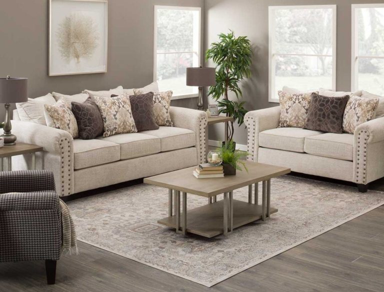 Dining room with a wooden table, six chairs, and a cozy fireplace in the background.